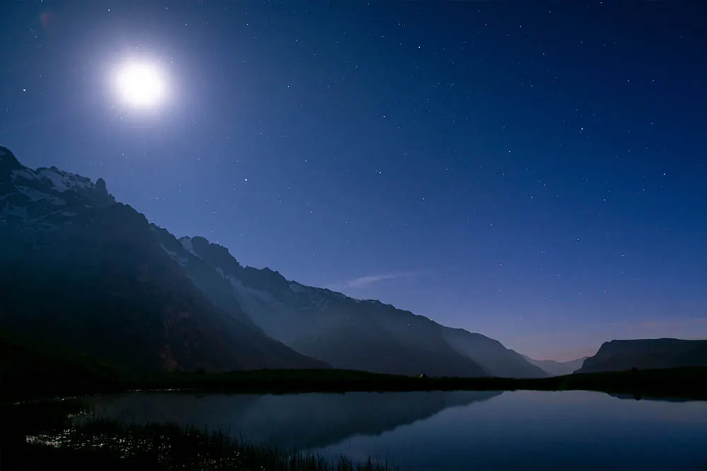 Night sky and moon over the mountains